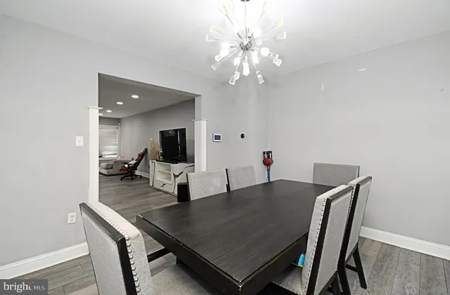 a dining room with furniture and wooden floor