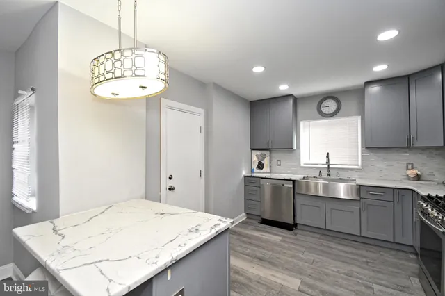 a kitchen with a sink and refrigerator