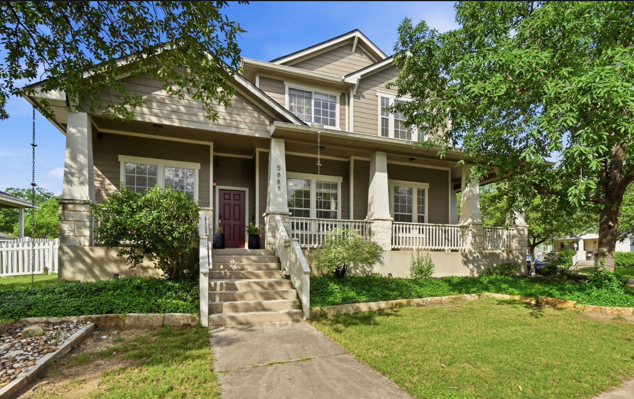 5888 Fergus Kyle, TX 78640 - Photo 32 of 40 A welcoming front porch, adorned with white railings and stone accents, frames this classic two-story residence.