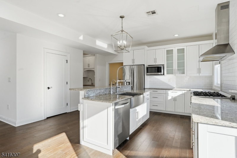 44 Manor Road Livingston, NJ 07039 - Photo 11 of 48 a kitchen with stainless steel appliances granite countertop a sink stove and refrigerator