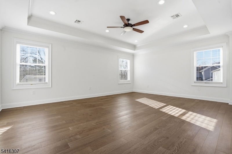 44 Manor Road Livingston, NJ 07039 - Photo 20 of 48 a view of an empty room with wooden floor and a window