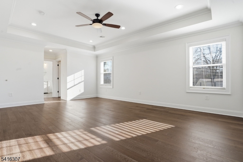 44 Manor Road Livingston, NJ 07039 - Photo 21 of 48 a view of an empty room with a window and wooden floor