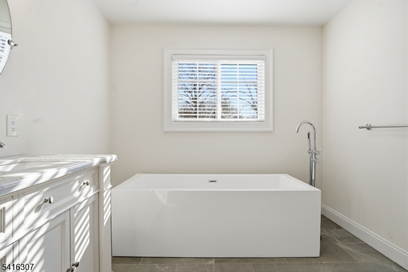 44 Manor Road Livingston, NJ 07039 - Photo 24 of 48 a white bath tub sitting next to a window