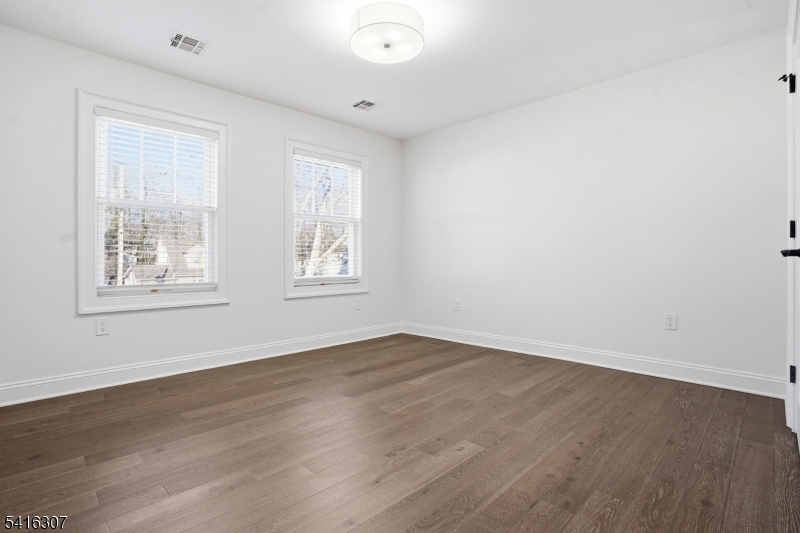 44 Manor Road Livingston, NJ 07039 - Photo 27 of 48 an empty room with wooden floor and windows