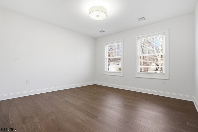 44 Manor Road Livingston, NJ 07039 - Photo 28 of 48 an empty room with wooden floor and windows
