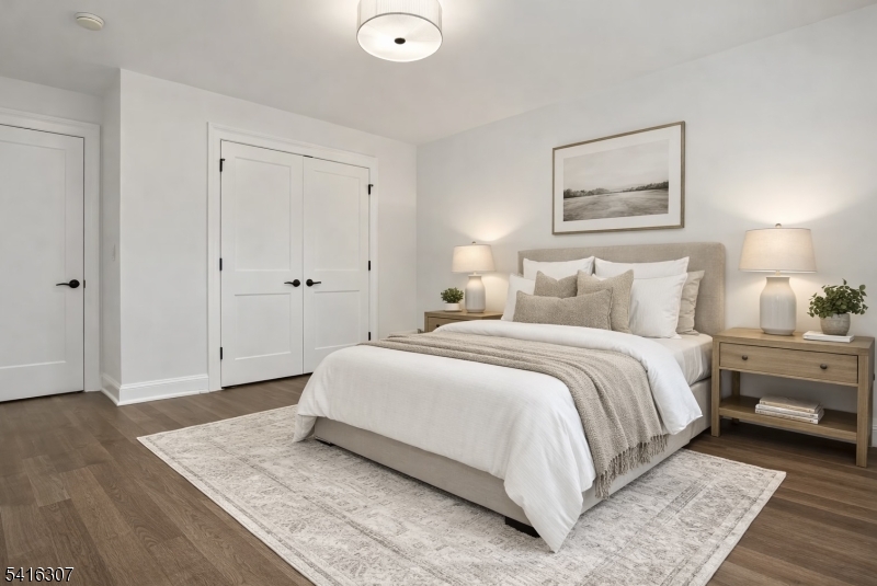 44 Manor Road Livingston, NJ 07039 - Photo 29 of 48 a bedroom with a bed and a painting on the wall