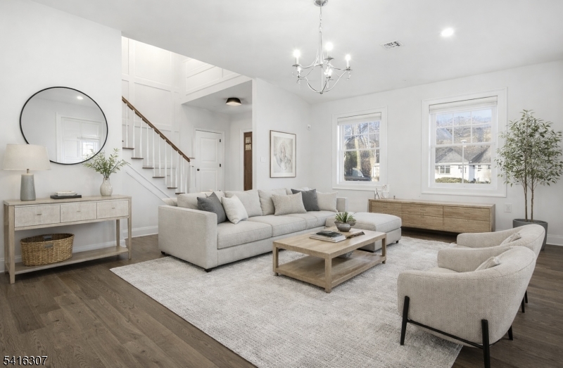 44 Manor Road Livingston, NJ 07039 - Photo 3 of 48 a living room with furniture a fireplace and a mirror