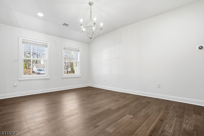 44 Manor Road Livingston, NJ 07039 - Photo 32 of 48 an empty room with wooden floor and windows