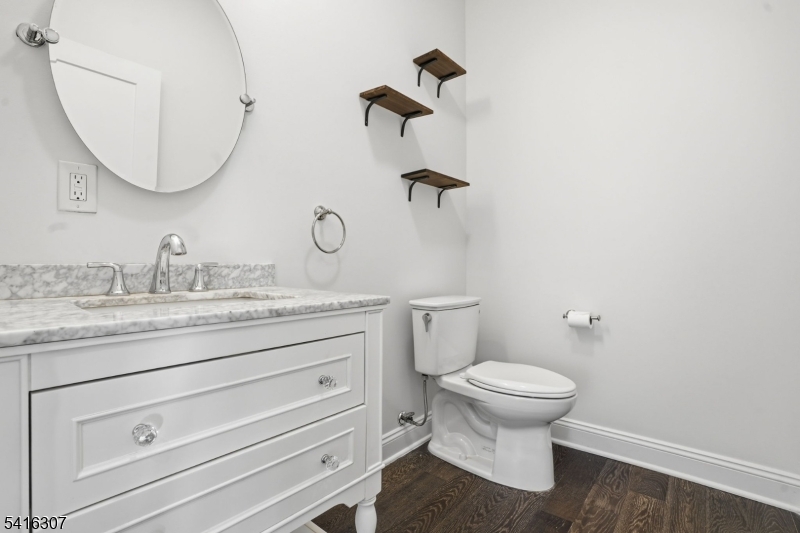 44 Manor Road Livingston, NJ 07039 - Photo 33 of 48 a bathroom with a granite countertop toilet sink and mirror