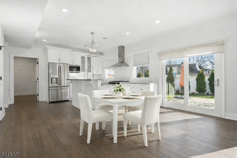 44 Manor Road Livingston, NJ 07039 - Photo 47 of 48 a view of a dining room with furniture large window and wooden floor
