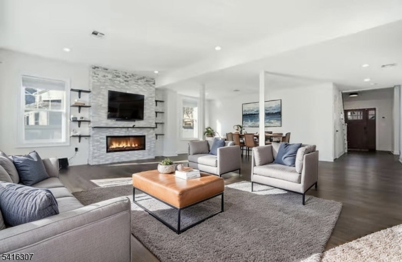 44 Manor Road Livingston, NJ 07039 - Photo 6 of 48 a living room with furniture a fireplace and a flat screen tv