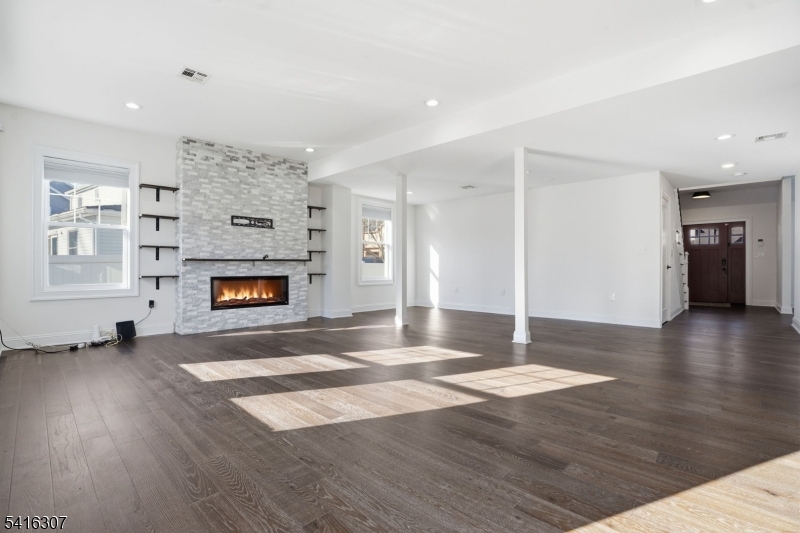 44 Manor Road Livingston, NJ 07039 - Photo 7 of 48 a view of an empty room with window and fire place