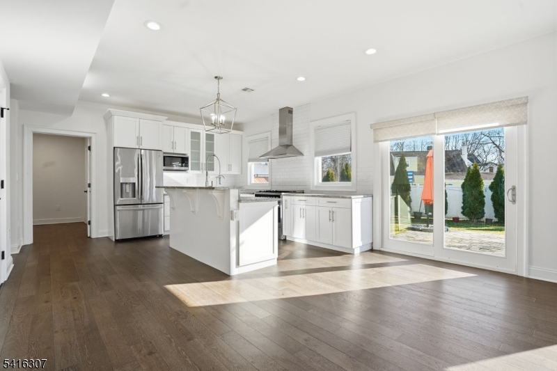 44 Manor Road Livingston, NJ 07039 - Photo 10 of 48 a large kitchen with cabinets and wooden floor
