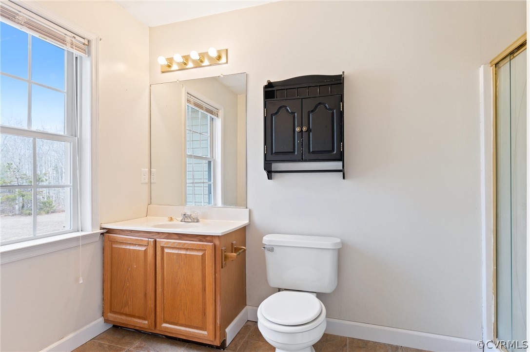 3165 Sandy Hook Road Sandy Hook, VA 23153 - Photo 12 of 25 a bathroom with a toilet a sink a vanity and mirror