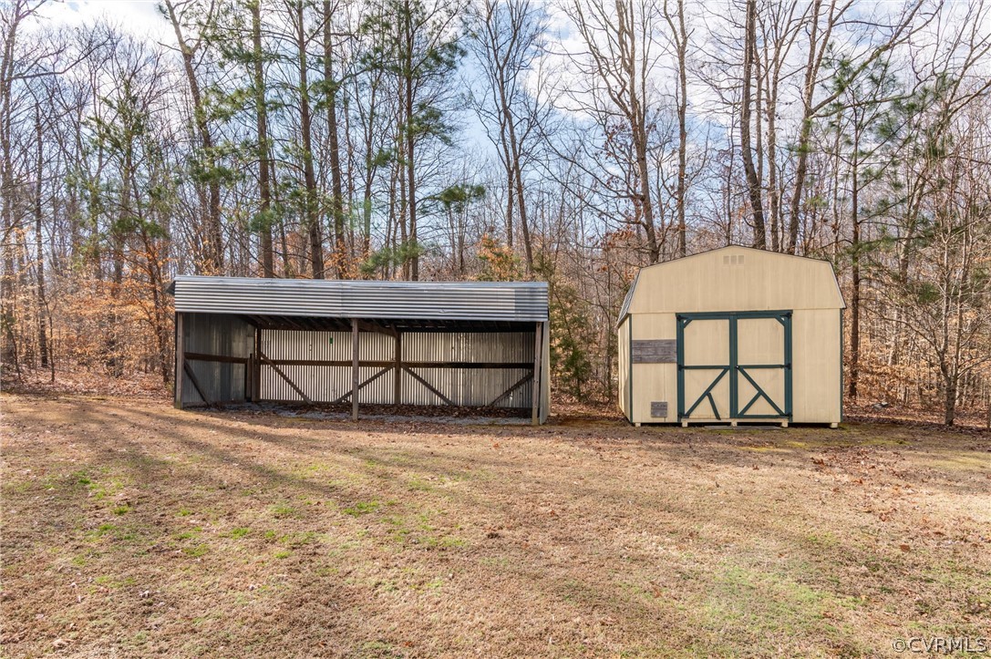 3165 Sandy Hook Road Sandy Hook, VA 23153 - Photo 23 of 25 a backyard of a house with a large tree and wooden fence