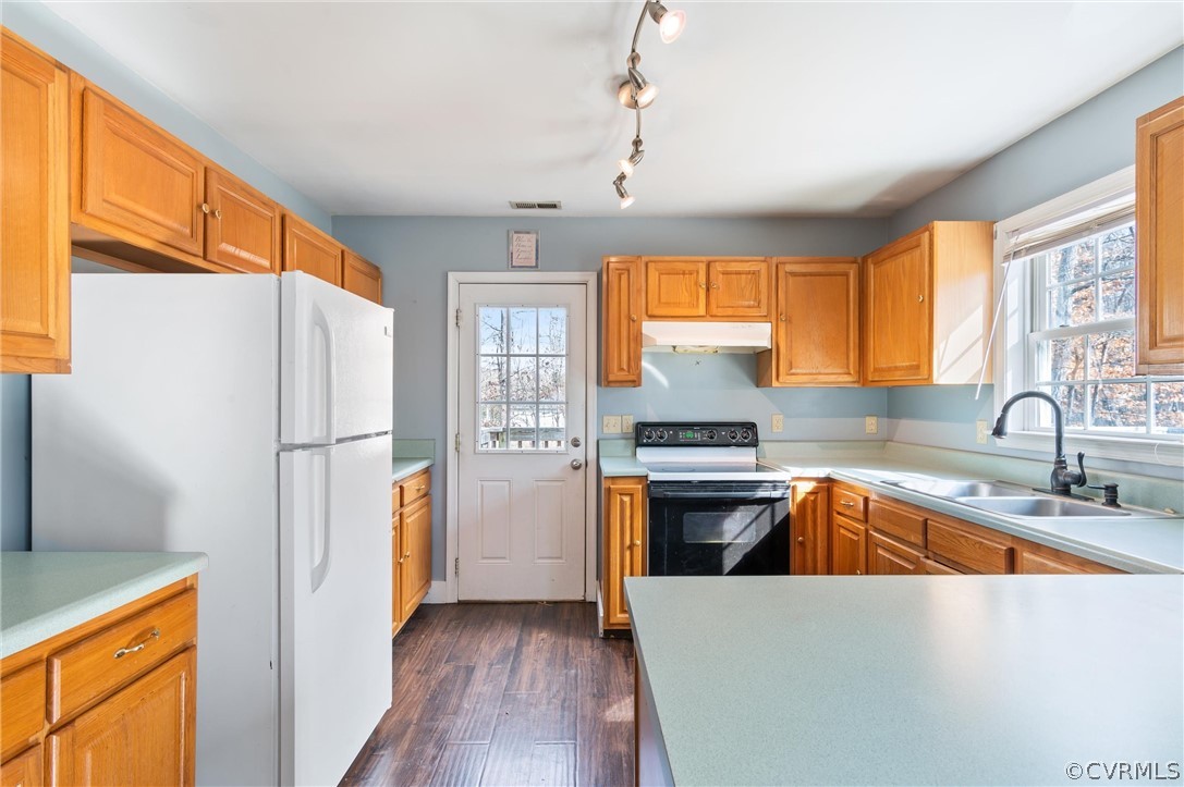 3165 Sandy Hook Road Sandy Hook, VA 23153 - Photo 7 of 25 a kitchen with stainless steel appliances granite countertop a refrigerator a sink dishwasher a stove and a dining table with wooden floor