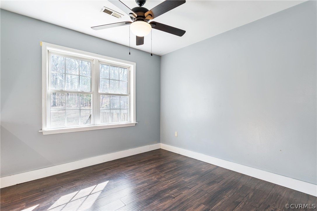 3165 Sandy Hook Road Sandy Hook, VA 23153 - Photo 8 of 25 an empty room with wooden floor fan and windows