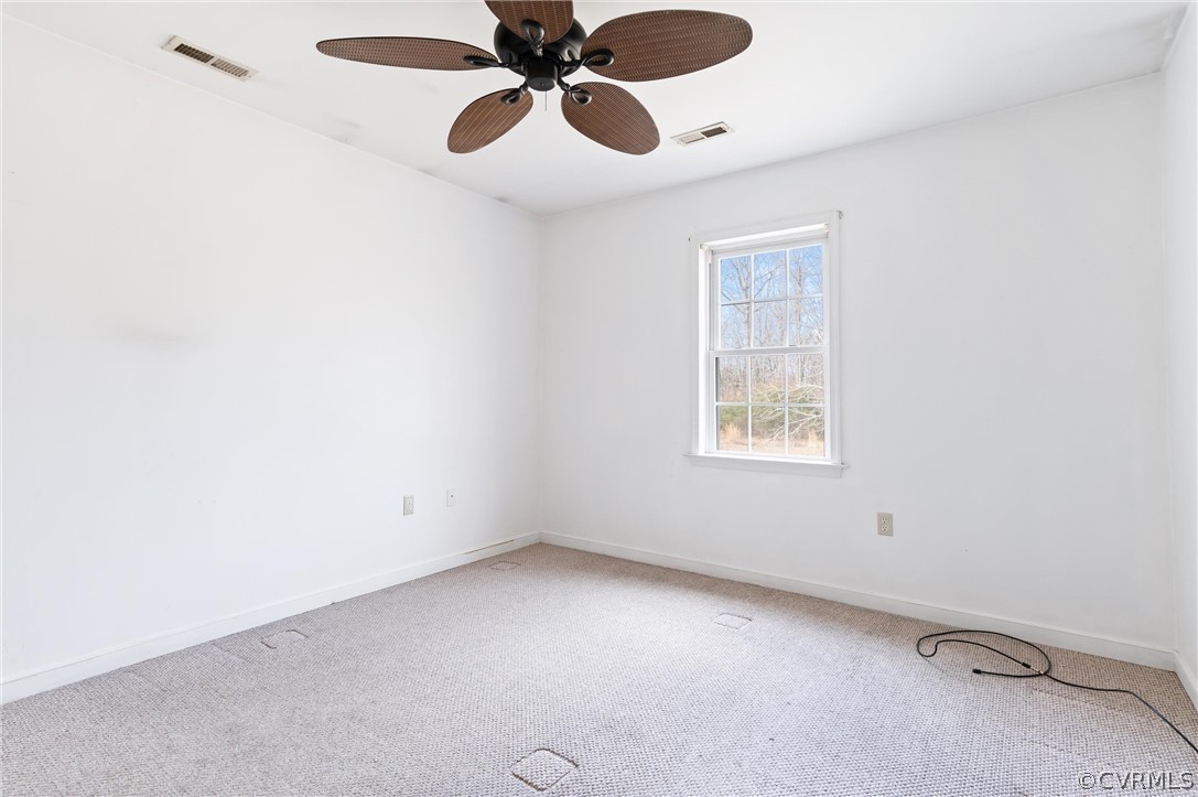 3165 Sandy Hook Road Sandy Hook, VA 23153 - Photo 10 of 25 an empty room with a window and a fan