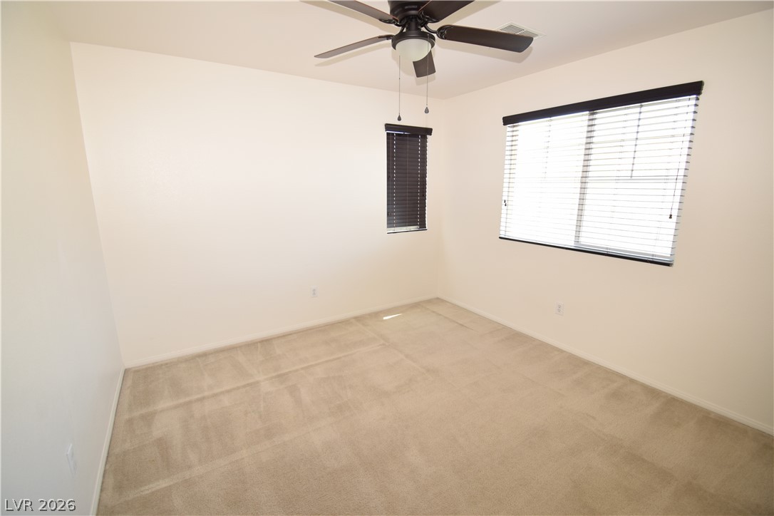 3622 Via Terracina Henderson, NV 89052 - Photo 19 of 22 Well-lit room featuring ample natural light and a practical ceiling fan for comfort.