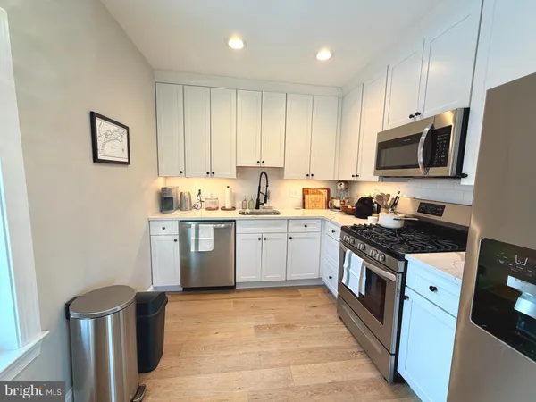 a kitchen with a sink stove and microwave