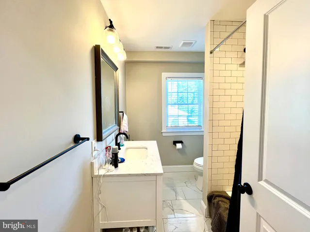 a bathroom with a tub sink and mirror