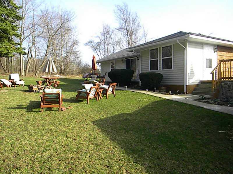 490 Mountain Cir Road Mount Pleasant, PA 15666 - Photo 5 of 20 Exterior Back. Enjoy back yard entertaining around the fire pit