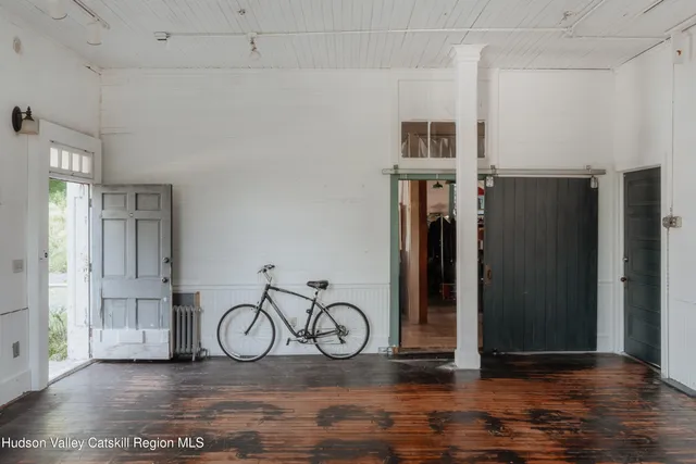 a view of a room with wooden floor and chair
