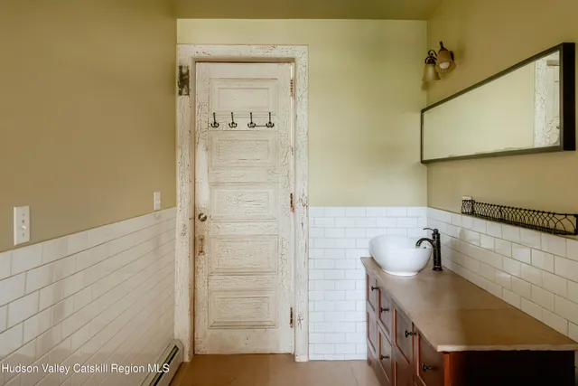 a view of a kitchen with a sink stainless steel appliances cabinets and wooden floor