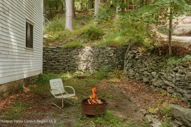 a backyard of a house with table and chairs