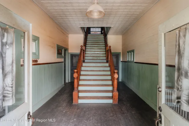 a view of entryway and hall with stairs