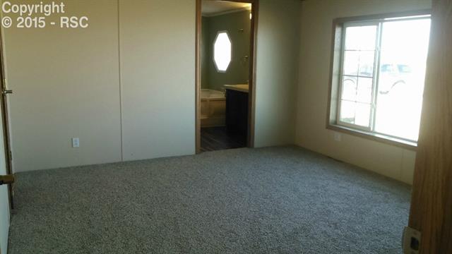 6020 Peerless Farms Road Peyton, CO 80831 - Photo 5 of 8 Master bedroom with his/her closets, 5 pc master bathroom and new carpet