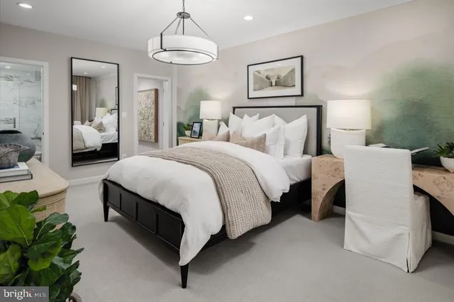 a spacious bedroom with a bed and a chandelier