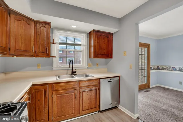 a kitchen with a sink cabinets and window