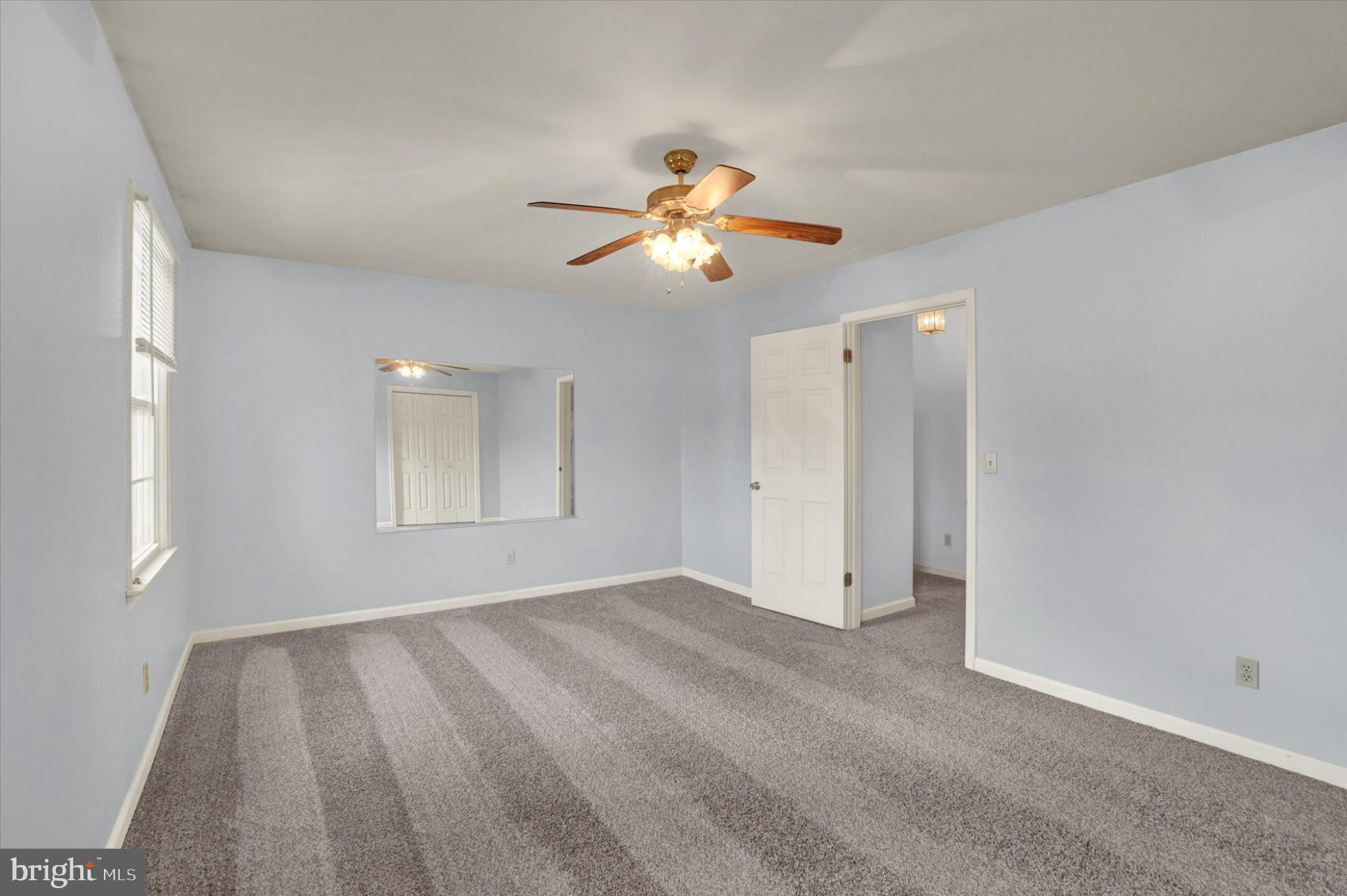 305 Chambers Ridge, Unit 305 York, PA 17402 - Photo 14 of 28 Spacious primary bedroom with soft blue hues.