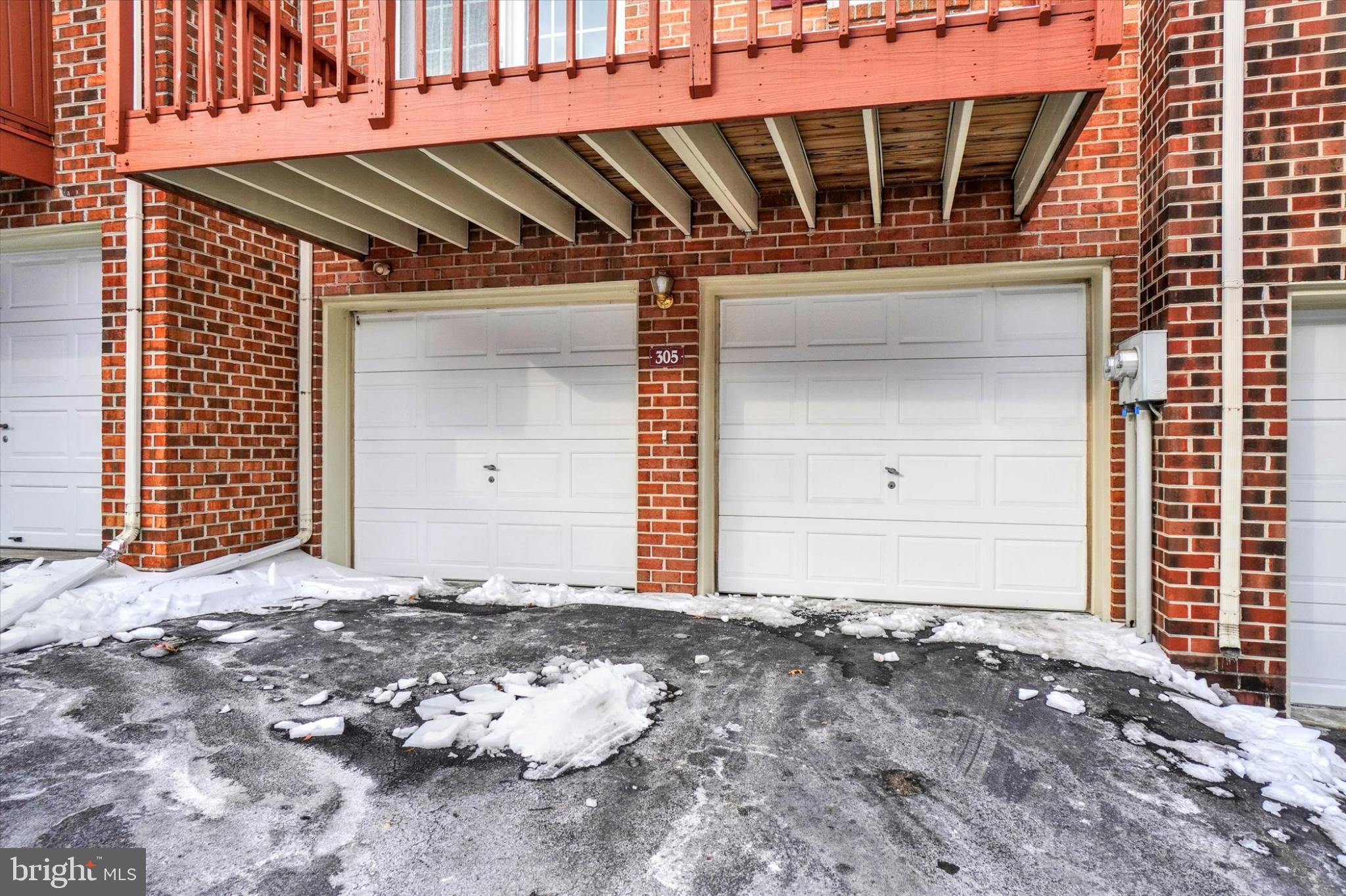 305 Chambers Ridge, Unit 305 York, PA 17402 - Photo 26 of 28 Charming brick facade with snowy driveway.