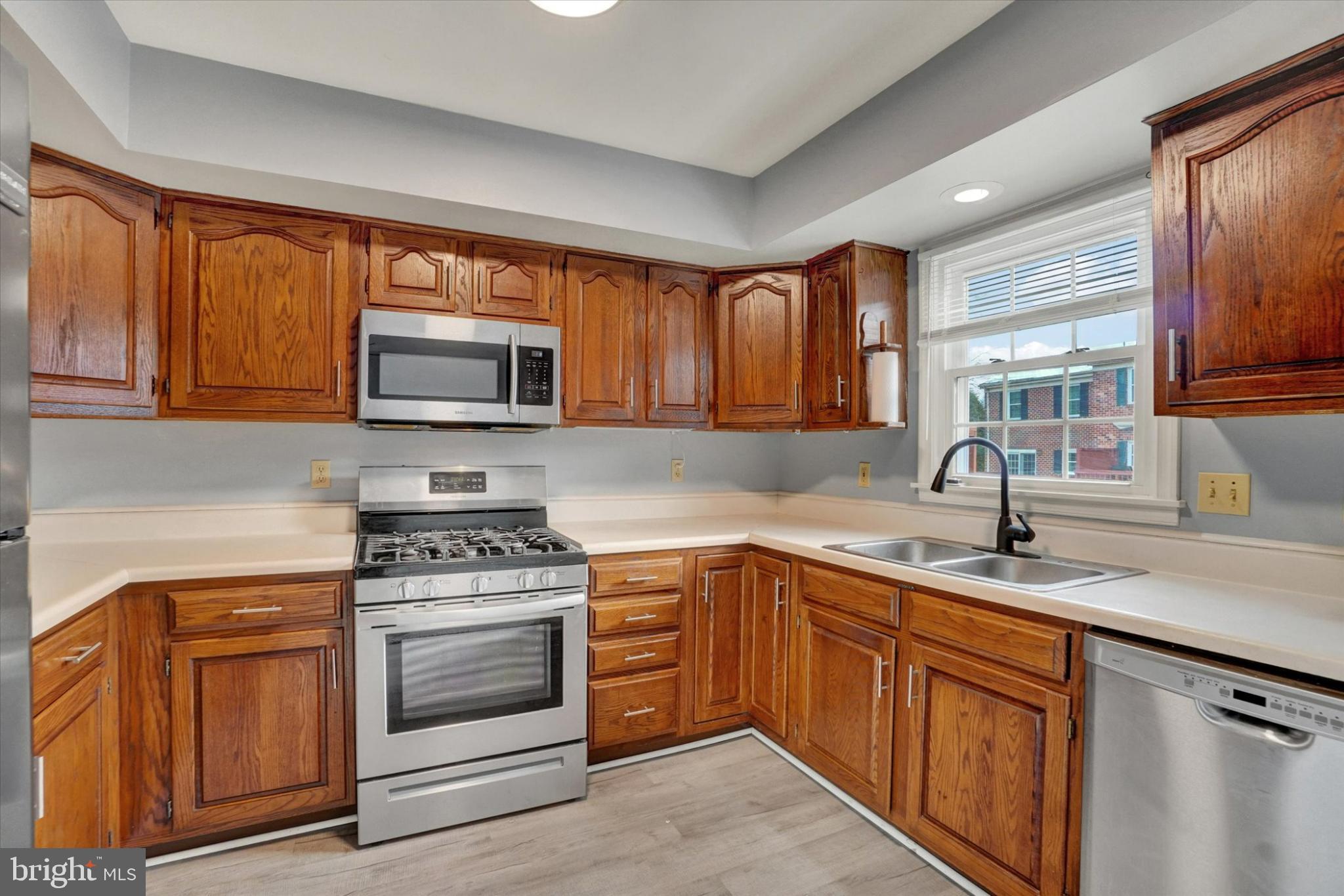 305 Chambers Ridge, Unit 305 York, PA 17402 - Photo 8 of 28 Modern kitchen with rich wood cabinetry.