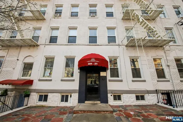 a view of a building with a umbrellas on a street