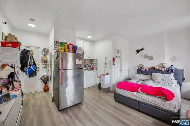 a living room with a couch and a wooden floor