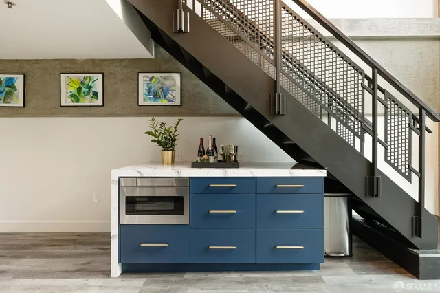 a kitchen with stainless steel appliances kitchen island granite countertop a sink and cabinets