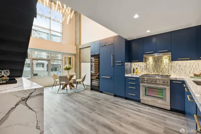 a kitchen with stainless steel appliances granite countertop a stove and cabinets