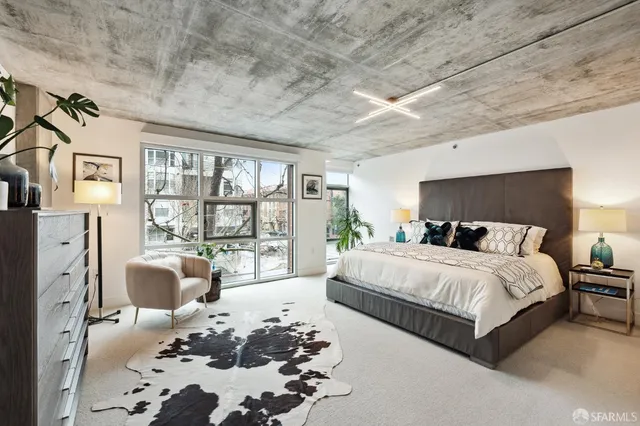 a bedroom with a large bed and a chandelier