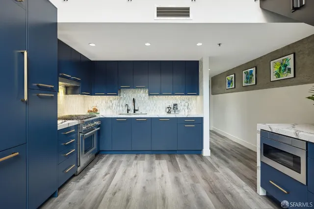 a kitchen with stainless steel appliances granite countertop a stove and a sink