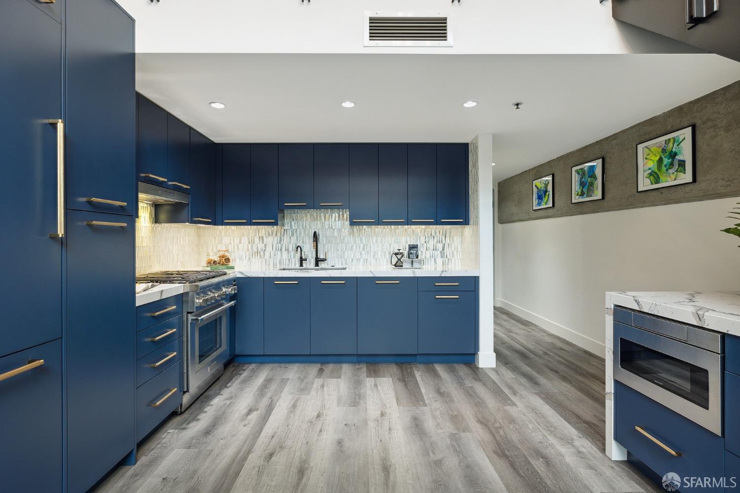 200 Brannan Street, Unit 130 San Francisco, CA 94107 - Photo 3 of 43 a kitchen with stainless steel appliances granite countertop a stove and a sink