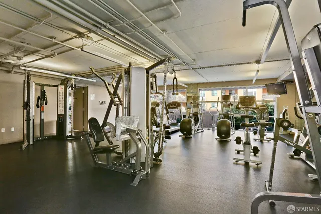 a spacious bedroom with a large window and a potted plant