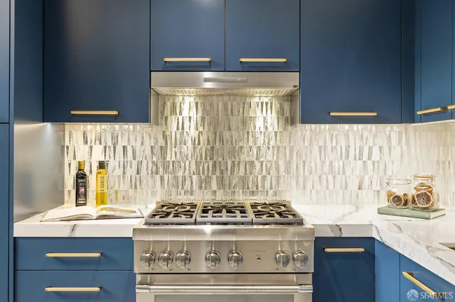 a stove top oven sitting inside of a kitchen