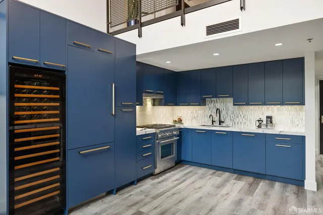 a kitchen with stainless steel appliances granite countertop a refrigerator and a sink