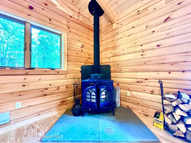 a view of a dresser with chair and wooden floor