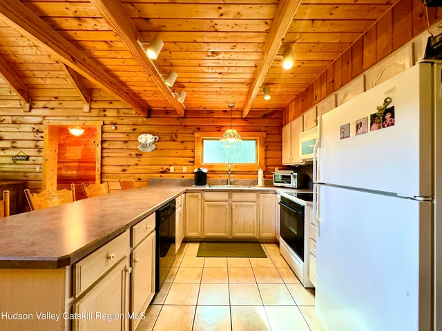 a kitchen with refrigerator and cabinets