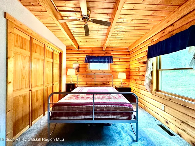 a bed sitting in a bedroom next to a window