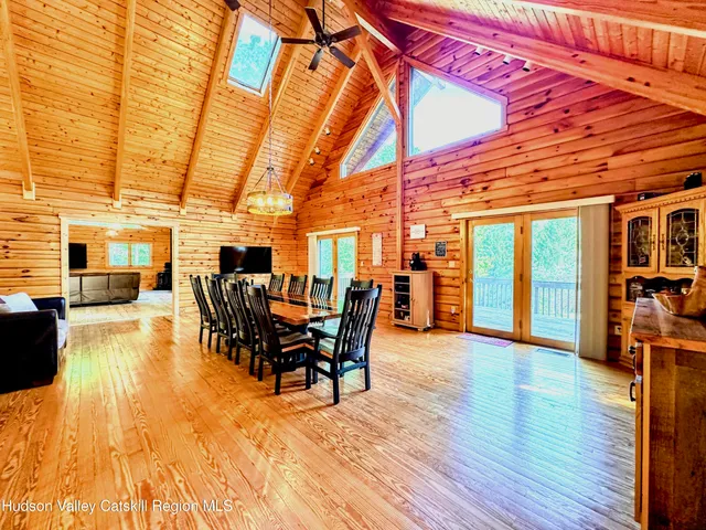 a dining room with furniture and wooden floor